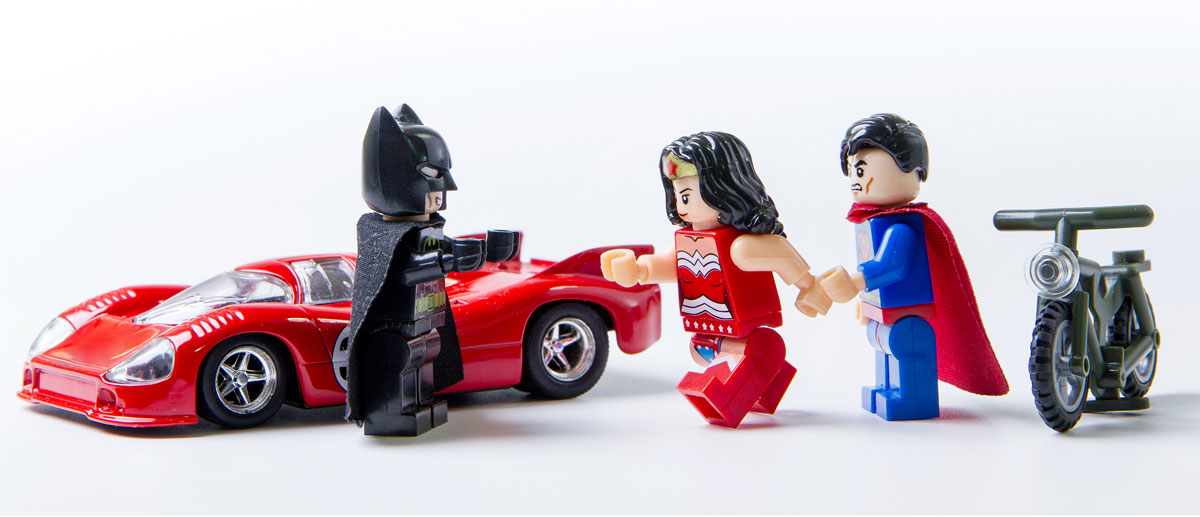 Lego Wonder Woman runs toward Batman and away from Superman